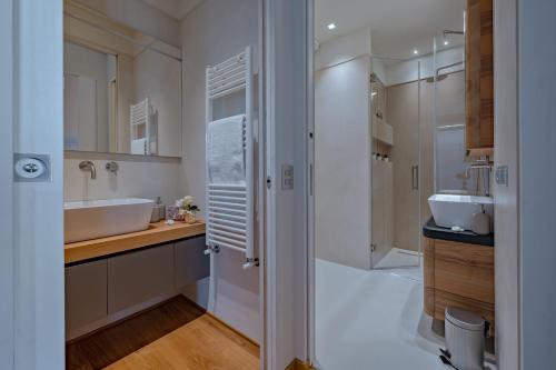 a bathroom with a tub and a sink at CHIANTI LUXURY APARTMENTS GREVE in Greve in Chianti