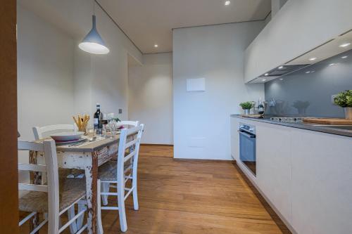 a kitchen with a table and chairs and a counter at CHIANTI LUXURY APARTMENTS GREVE in Greve in Chianti