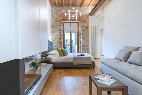 a living room with a bed and a couch at CHIANTI LUXURY APARTMENTS GREVE in Greve in Chianti