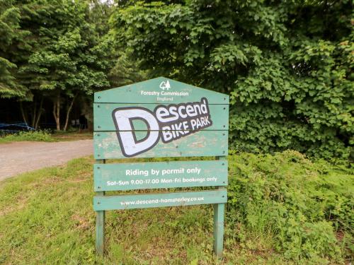 a sign in the grass next to a road at Blackburn Cottage Barn in Hamsterley