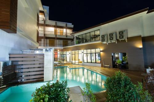 a swimming pool in the middle of a building at Mamaison Hotel in Buriram