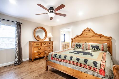 a bedroom with a bed and a ceiling fan at Evergreen Getaway Fire Pit and Wood Fireplace in Townsend