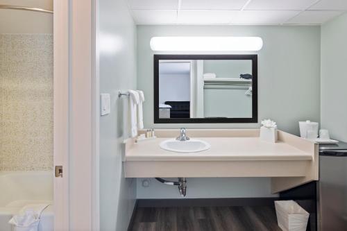 a bathroom with a sink and a mirror at Vagabond Inn Glendale in Glendale