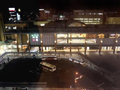 
a city street filled with lots of traffic at night at Hotel Abest Nagano Ekimae in Nagano
