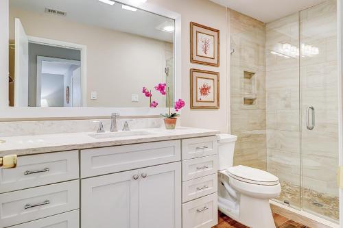 a bathroom with a toilet and a sink and a shower at Alexander Beach House in Hilton Head Island