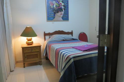 a bedroom with a bed and a lamp on a night stand at My Sweet House in Arequipa
