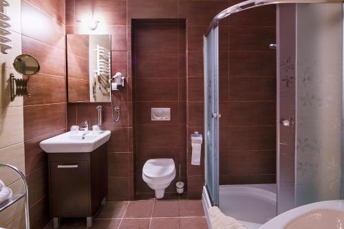 a bathroom with a toilet and a sink and a shower at Boutique Hotel's II Rewolucji in Łódź