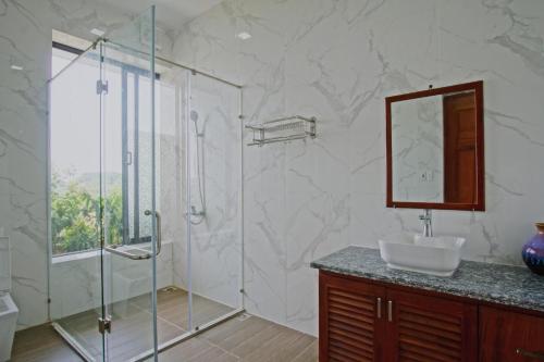 a bathroom with a shower and a sink and a mirror at Tản Đà Lake View Ba Vì - Venue Travel in Hanoi