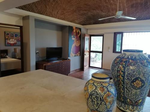 two large vases sitting on a table in a room at Casa Maria en La Manzanilla in La Manzanilla