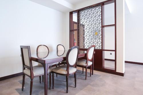 a dining room with a table and chairs at SITARA HOTEL APARTMENT in Dubai