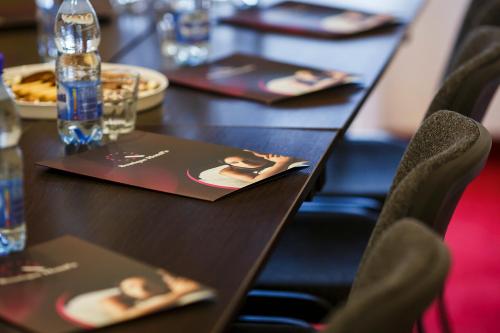 a table with chairs and plates of food on it at Boutique Hotel's II Rewolucji in Łódź