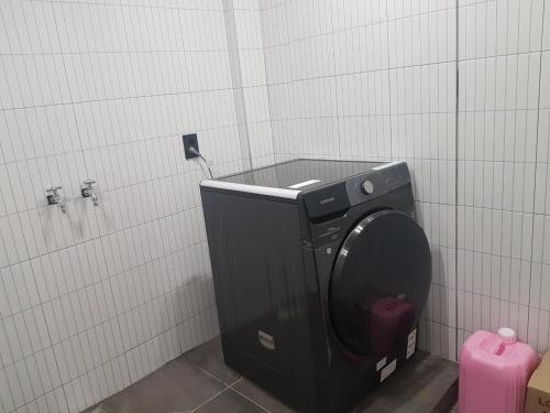 a bathroom with a toilet in a stall at Anseong City Hotel in Anseong