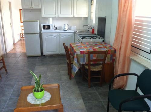 a kitchen with a table and a dining room at Valentinos House in Paphos City