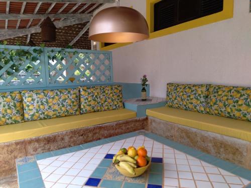 a restaurant with a bowl of fruit on the floor at Barbanera Club & Hotel de Charme in Caucaia