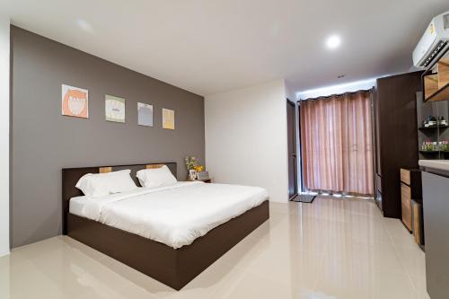 een slaapkamer met een groot bed en een groot raam bij My Space @ Chaosua69 in Ban Pak Khlong Khwang