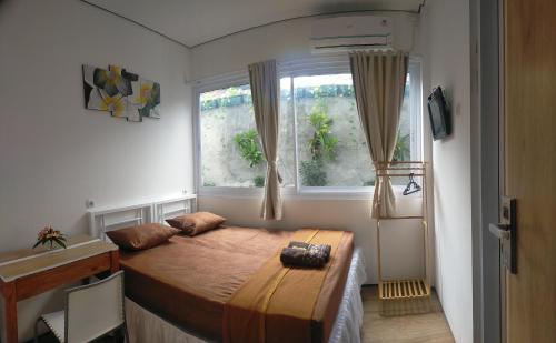 Postel nebo postele na pokoji v ubytování Rion Hostel Bogor