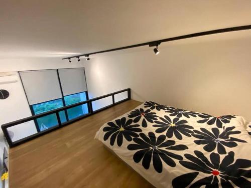 een slaapkamer met een bed met een zwart-witte deken bij KL Sentral Loft , EST Bangsar #2, LRT in Kuala Lumpur