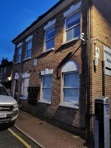 a brick building with a parking meter in front of it at Unique Studio I - Private Studio with ensuite in Maidstone