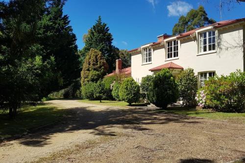 a large white house with trees and a driveway at The French House St Helens in St Helens