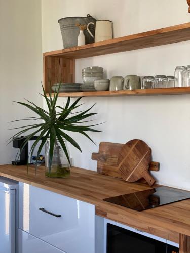 a kitchen with a wooden table and a basket on top of it at Bay Breeze Boutique Accommodation in Batemans Bay