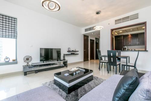 a living room with a couch and a table at 1BR Boulevard View 29 Blvd T2 Downtown in Dubai