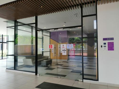 an empty lobby of a building with glass doors at Conezion Residence Putrajaya nearby IOI City Mall in Putrajaya