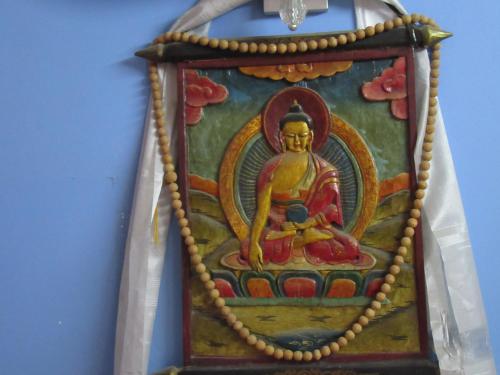 a painting of a buddha hanging on a wall at STUPA VIEW INN in Kathmandu