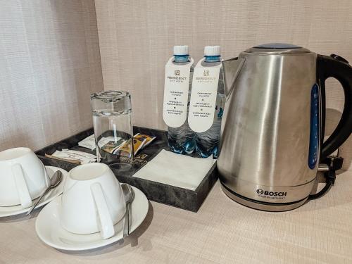 a kitchen counter with a tea kettle and cups at Resident City Hotel in Almaty