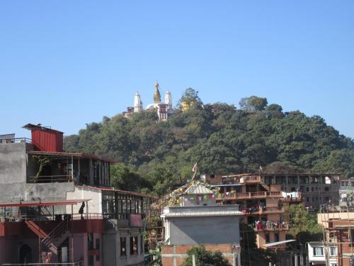 a hill with temples on top of a city at STUPA VIEW INN in Kathmandu