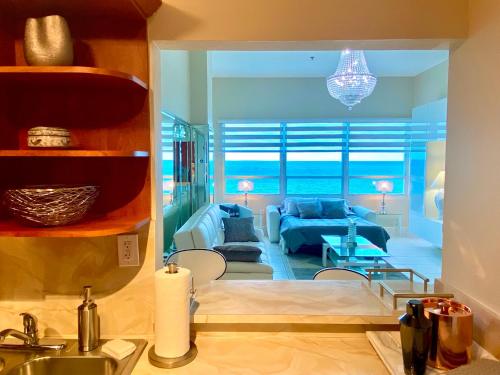 a living room with a view of the ocean at Castle Beach Resort Condo-Penthouse or Deluxe 1BR-Direct Ocean View and access- Free parking in Miami Beach