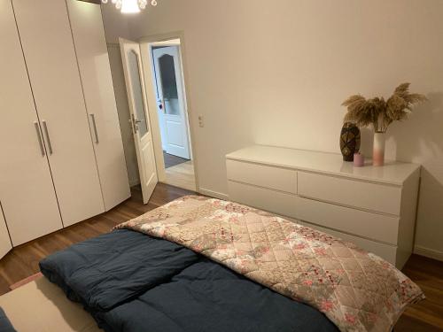 a bedroom with a bed and a dresser and a closet at Geräumige und schöne Wohnung direkt in der Lübecker Innenstadt in Lübeck