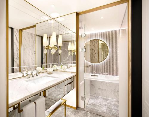 a bathroom with two sinks and a shower at Sofitel Ambassador Seoul Hotel & Serviced Residences in Seoul