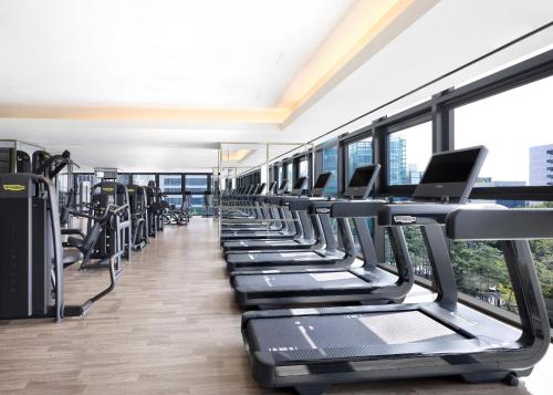 a row of treadmills in a gym with windows at Sofitel Ambassador Seoul Hotel & Serviced Residences in Seoul