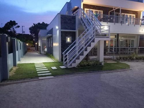 a house with a staircase in front of it at Maykenn Beach in Ocoy