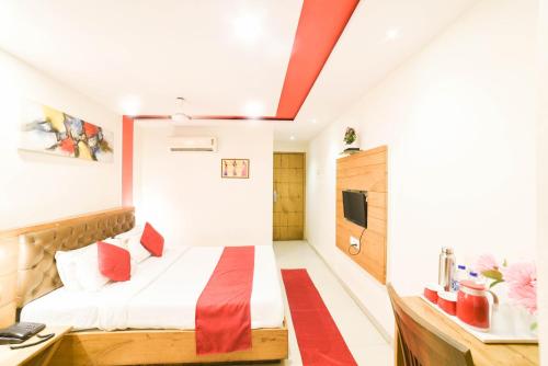 a hotel room with a bed and a tv at Hotel Grandeur-Near Mumbai International Airport in Mumbai