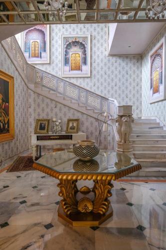 a room with a staircase with a table in it at Rajmahal Palace RAAS in Jaipur
