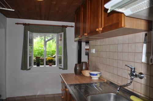 a kitchen with a sink and a window at Donovaly 15 in Donovaly