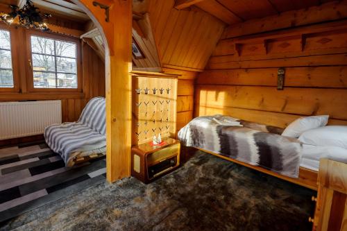 a bedroom with two beds in a log cabin at Dom Zako in Zakopane