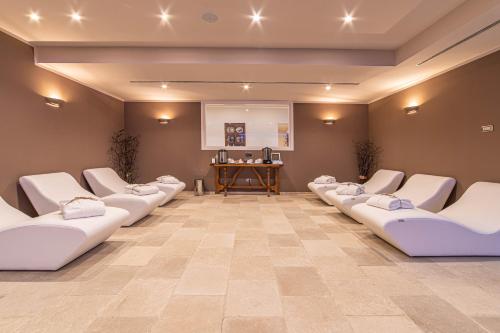 a row of white chairs in a waiting room at Moresco Agriturismo in Moresco