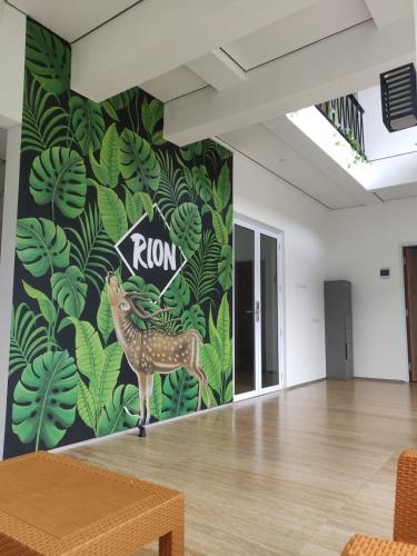 a room with a mural of a deer on the wall at Rion Hostel Bogor in Bogor