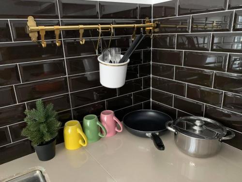 a kitchen counter with a sink with utensils at Hidden Gem @ Marina View Villas PD in Port Dickson
