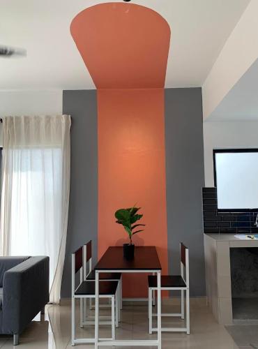 a dining room with a table with a plant on it at Hidden Gem @ Marina View Villas PD in Port Dickson