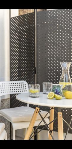 a table with two chairs and a glass vase at Luxury apartments SKALINADA near beaches, Tisno - Dalmatia in Tisno