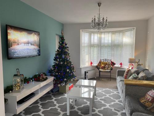 a living room with a christmas tree in it at Beautifully presented 6 bed 5 & a half bath house in Newcastle upon Tyne