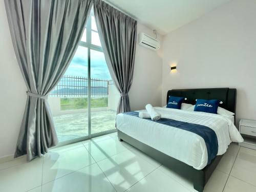 a bedroom with a bed and a large window at Langkawi Cozy Holiday Home at Taman Simfoni by Zervin in Kuah