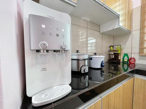 a white coffee machine sitting on a kitchen counter at Langkawi Cozy Holiday Home at Taman Simfoni by Zervin in Kuah
