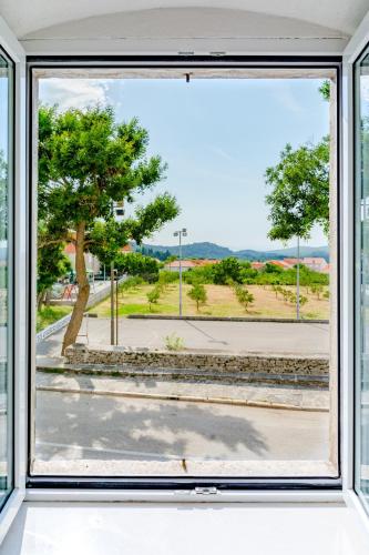 a window with a view of a street at Apartment Magdalena in Nerežišće
