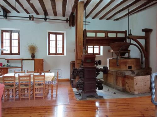 a room with a table and chairs and a machine at Molino De Pradillo in Pradillo