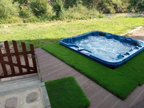 a hot tub in the grass next to a bench at Molino De Pradillo in Pradillo