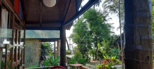 an outside view of a building with plants and trees at Peace Garden Beach Resort in Canacona